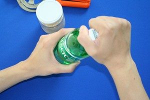 image showing a hand affected by rhizarthrosis who has difficulty opening a bottle